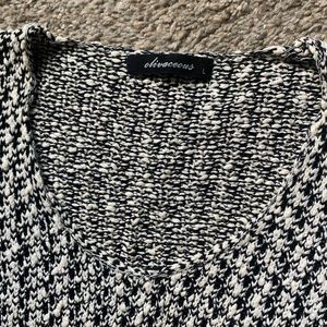 Olivaceous black and white sweater.